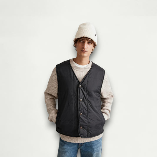 Azirado men's quilted liner vest in black worn over a light sweater for a stylish layered look