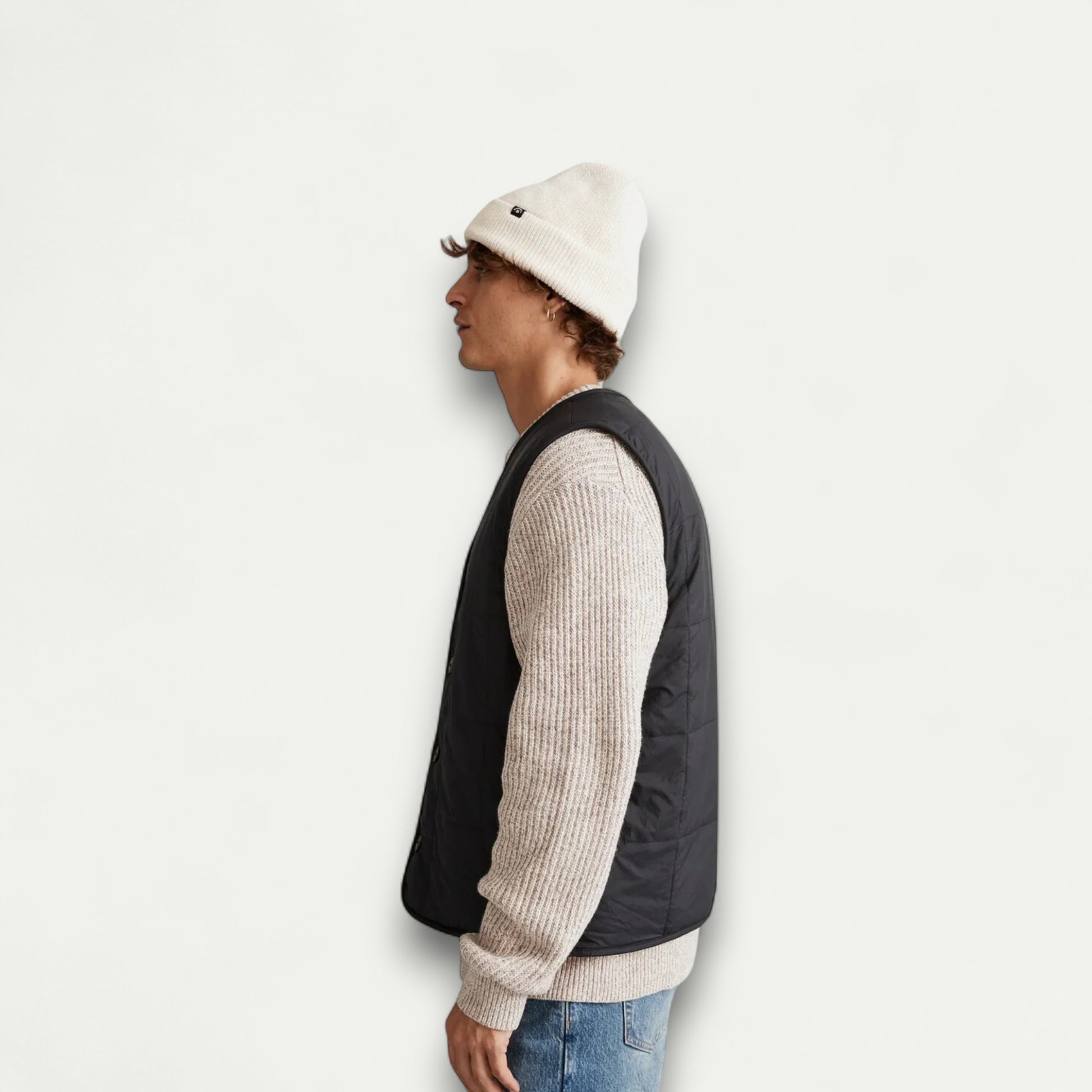 Azirado men's quilted liner vest in black worn over a light sweater, perfect for layering and cool weather
