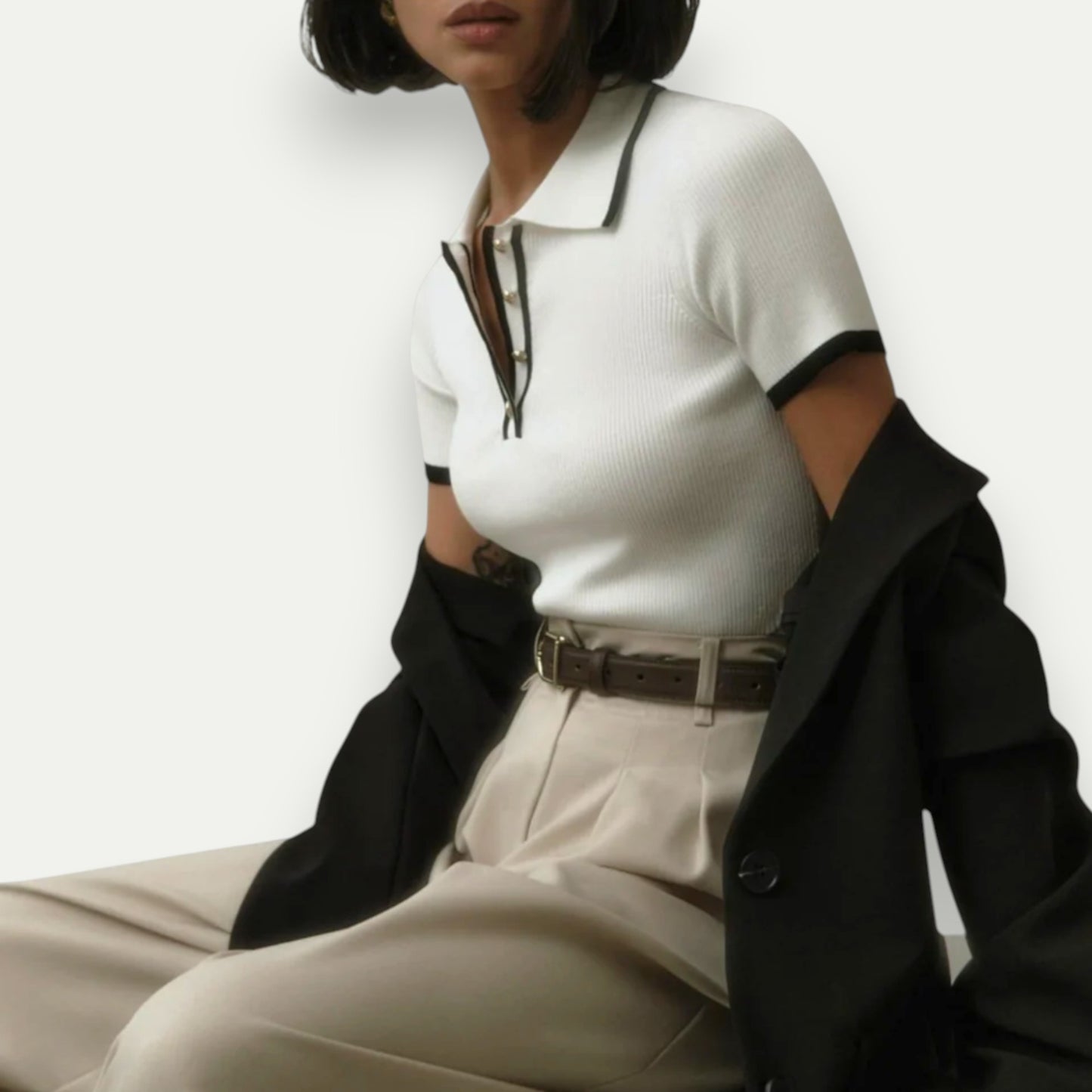 Azirado women's cropped polo shirt in white with black trim, styled with high-waisted pants